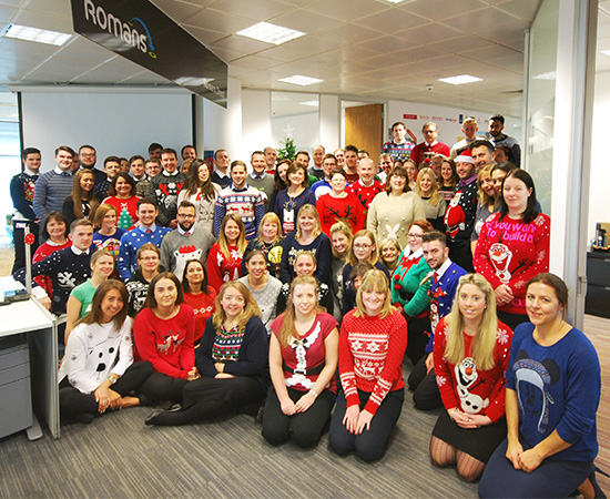 group photo with loads of members of staff gather round for Christmas photo 